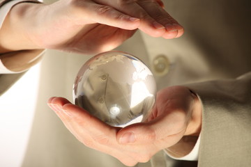 businessman holding mini globe