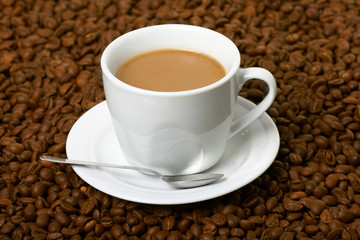 Cup with coffee, costing on coffee grain