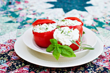 Herbed Stuffed Tomatoes with caps on top.
