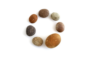 circle of seven pebbles, one larger than the others