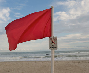 Red flag at the beach during hurricane season to warn of danger.