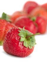 Fresh juicy berries of a strawberry on a white background