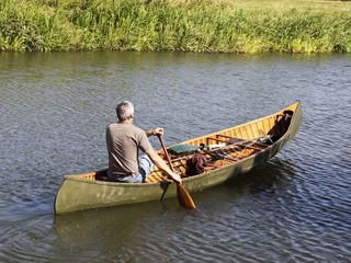 Foto op Canvas man in a canoe © emjay smith