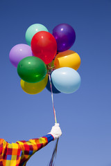 A clown holding balloons