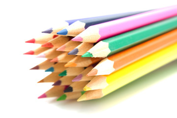 colored pencils over white background