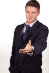businessman showing a handshake to the camera