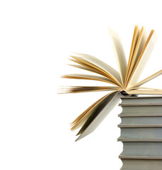 A pile of books and the one open at top