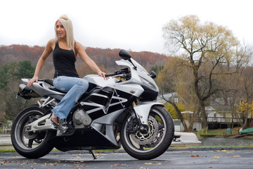 Fototapeta na wymiar Blonde Woman On a Motorcycle