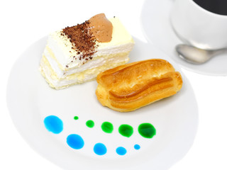 Sponge cakes and custard cake on plate with fruit spots.Isolated