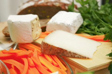 delicatessen cheese on cut board