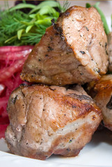 fried meat with potherbs on the plate