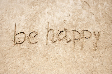 Be happy handwritten in sand for natural, symbol,tourism