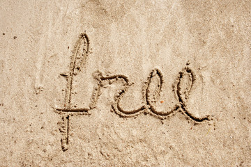 Free handwritten in sand on a beach