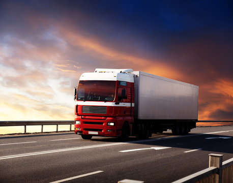 truck on highway and sunset