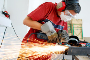 metal worker with a grinder and a lot of sparks