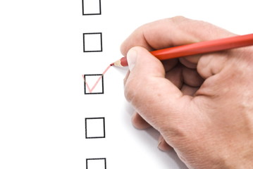 Hand with red pencil and check box