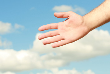 hand the background of blue sky