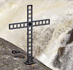 Religious cross set in rock