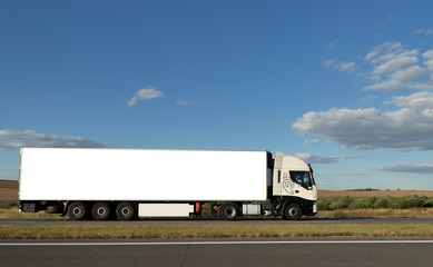 Long white truck on highway