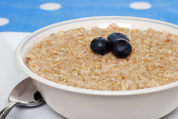 closeup oatmeal with blueberries focus on berries