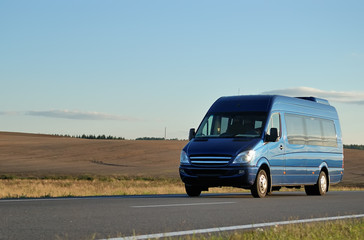 Blue minibus on highway - obrazy, fototapety, plakaty
