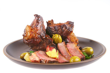 rib's and olives close up on old style dish