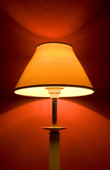 an isolated lamp with a red wall for the background