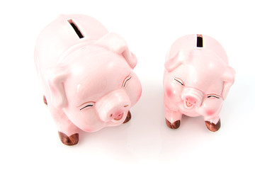 Two laughing pink piggy bank over white background
