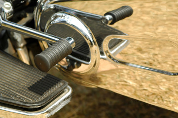 motorcycle gearshift and foot-plate reflections in chrome