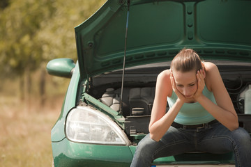 sad woman with broken car