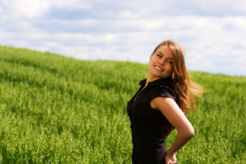 Fototapeta na wymiar Happy young woman in a field.