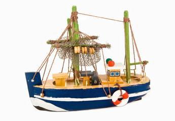 A small toy fishing ship with a lifeline on its side