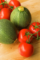 Vegetable background. Fresh tomatoes and courgettes