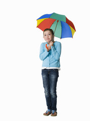 Young girl sheltering under a colorful umbrella