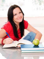 smiling brunette woman studying
