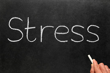 Stress written on a blackboard.