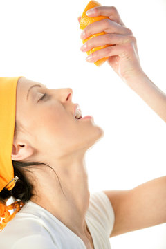 Woman Squeezing Orange Into Mouth