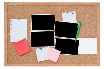 Cork board with blank photo prints and notes