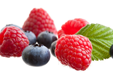 Raspberries and blueberries isolated on white background