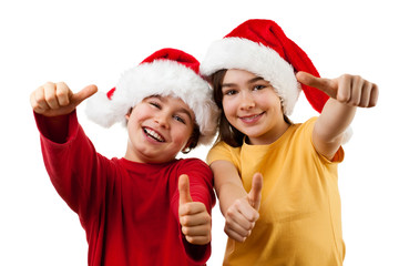 Kids wearing Santa Claus hats showing OK sign , isolated