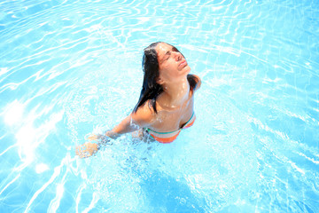 Fototapeta na wymiar woman enjoying a swimming pool