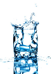 Ice cube splashing into glass of water, isolated on white