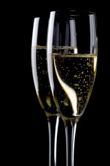 Two glasses champagne on black close up