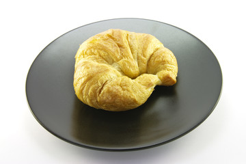 Croissant on a Black Plate
