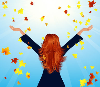 Girl throwing up autumnal leaf