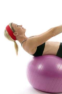 sit ups strength pose middle age woman fitness core ball