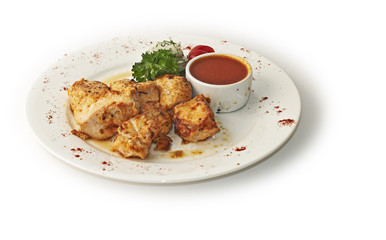 grilled chicken with a sauce and green