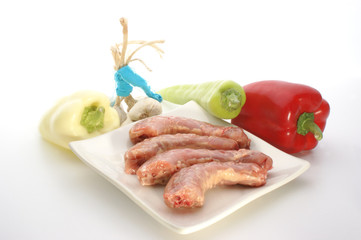 raw turkey neck with vegetables on a plate