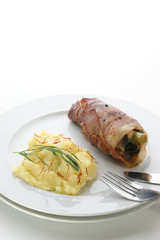 mashed potato and chicken roll on a white plate