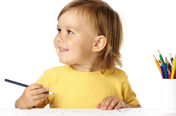 Happy child draw with crayons and smile